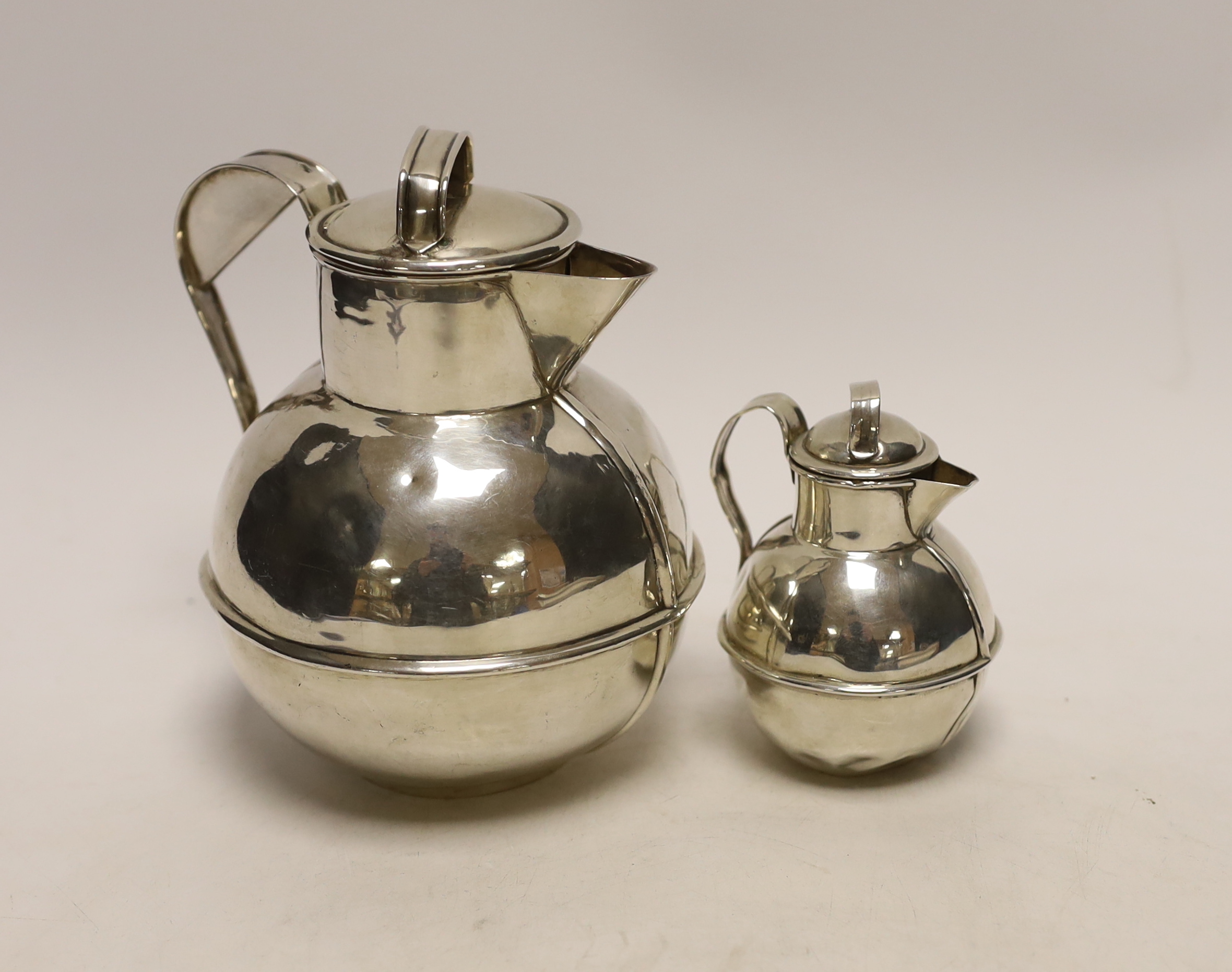 A late Victorian silver 'Guernsey' milk can, retailed by Roger of Guernsey, Chester, 1900, 15.5cm and a smaller silver milk can, Birmingham, 1903, 7.6oz.
